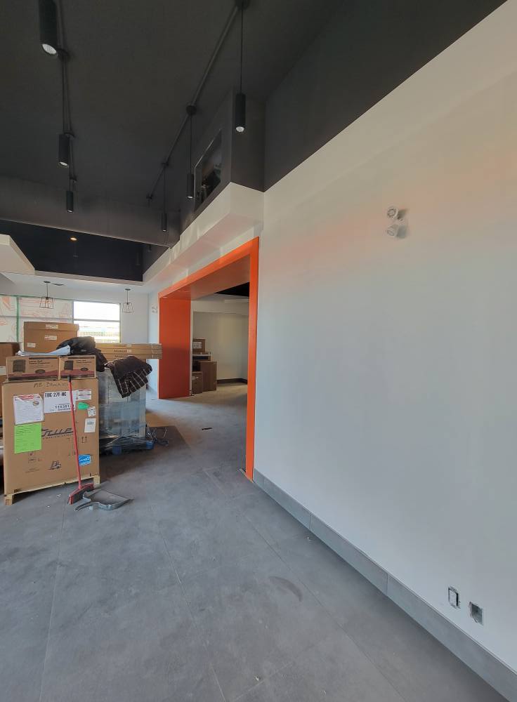 Commercial space with white walls and orange archway